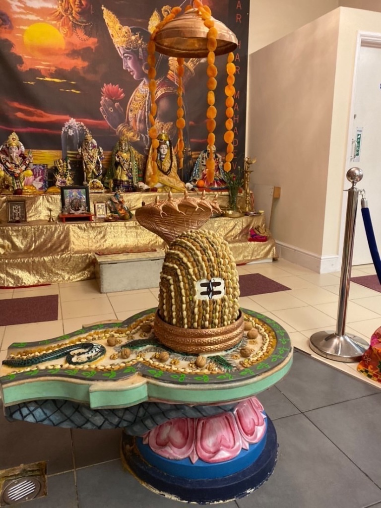 A grain shringar with hanging garland and serpent canopy.