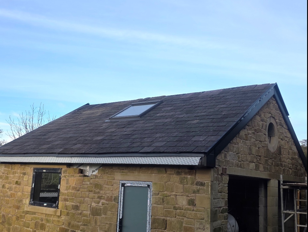 Completed slate roof on stone building