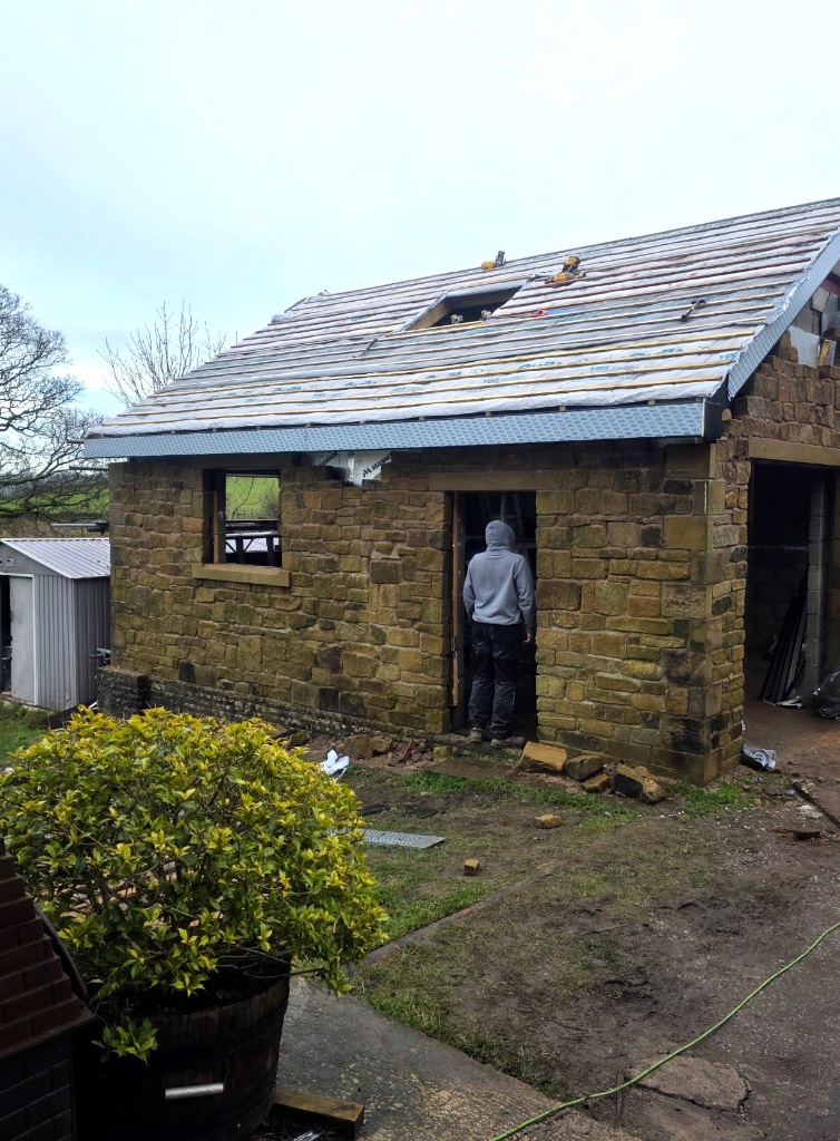 Stone building roofing in progress