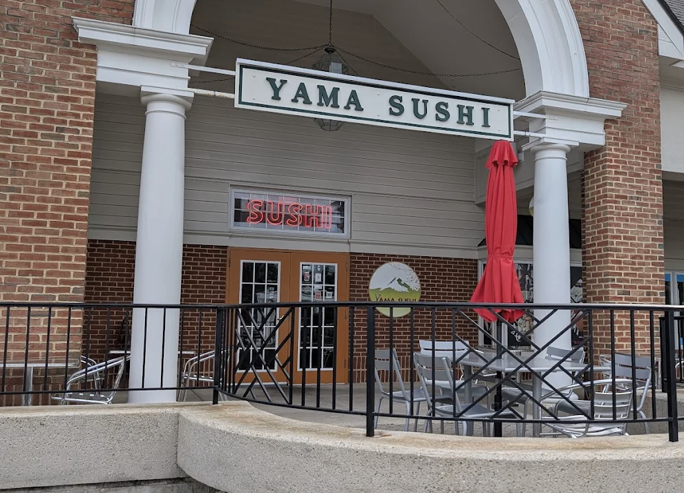 Yama Sushi restaurant exterior with brick facade and red umbrella