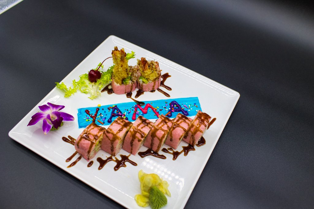 Sushi roll with cocktail on dark slate