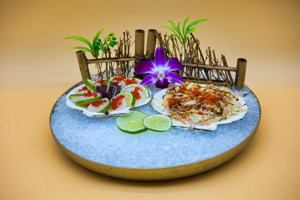 Sashimi platter with orchid and cocktail