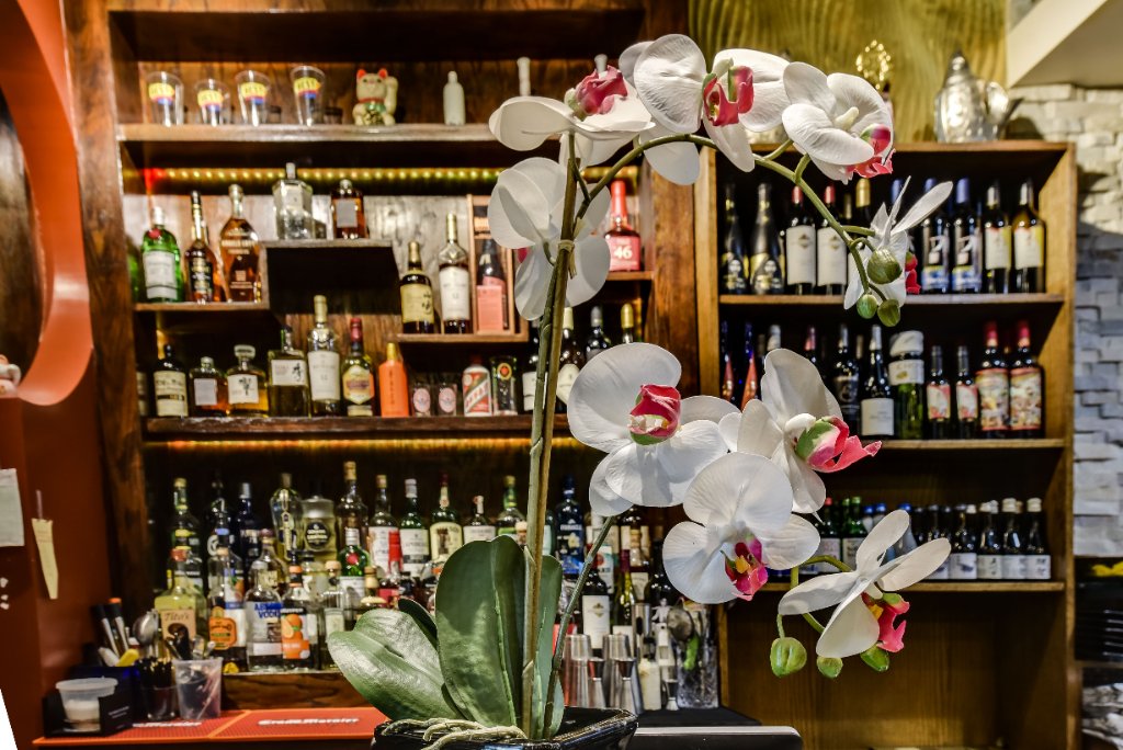 Bar area with orchid floral arrangement