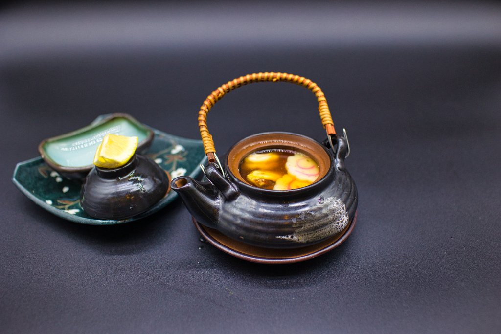 Eel roll with Japanese geisha doll and sake