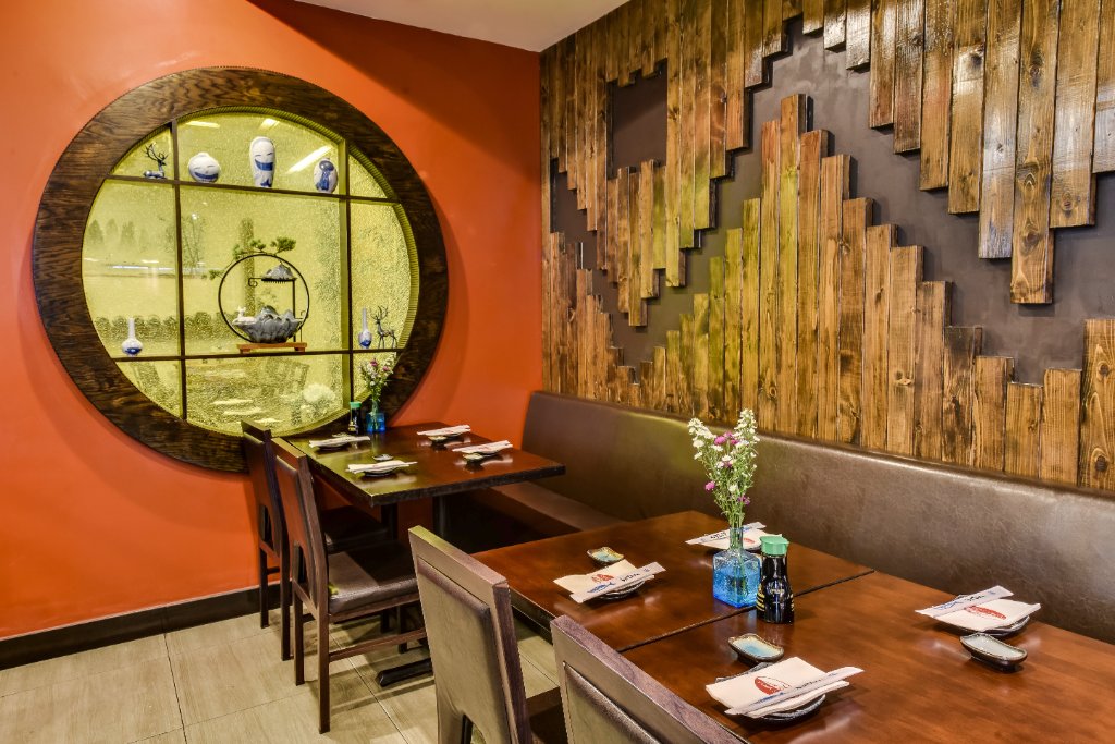Dining room with circular window and wood wall art