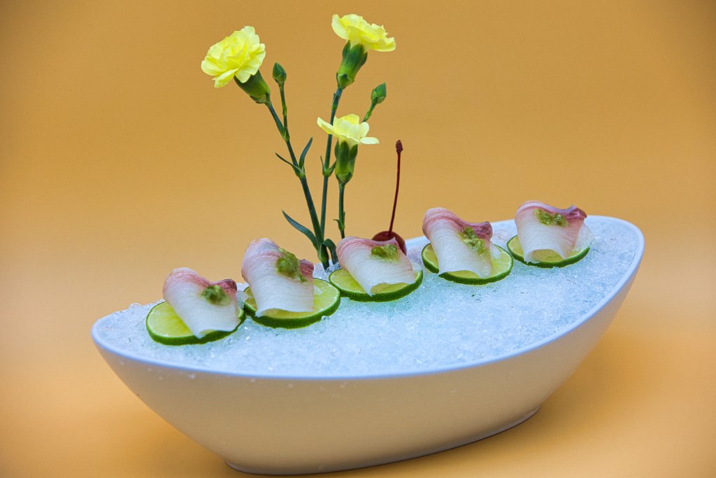Sashimi on ice with carnation flowers