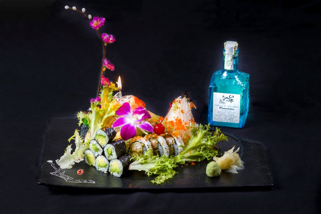 Artfully plated sushi roll with pink flowers