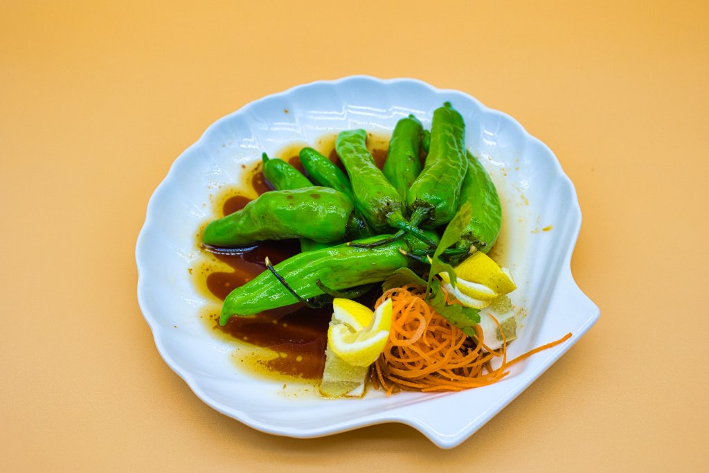 Shishito peppers in shell dish with lemon