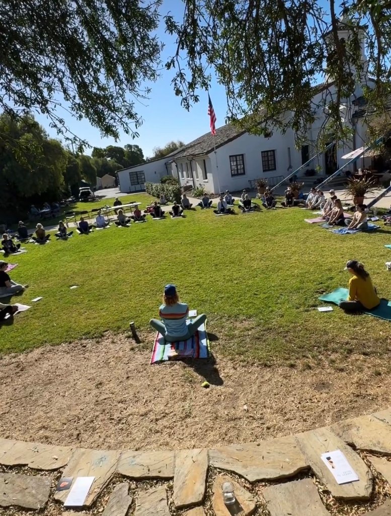 Outdoor yoga retreat class on the lawn