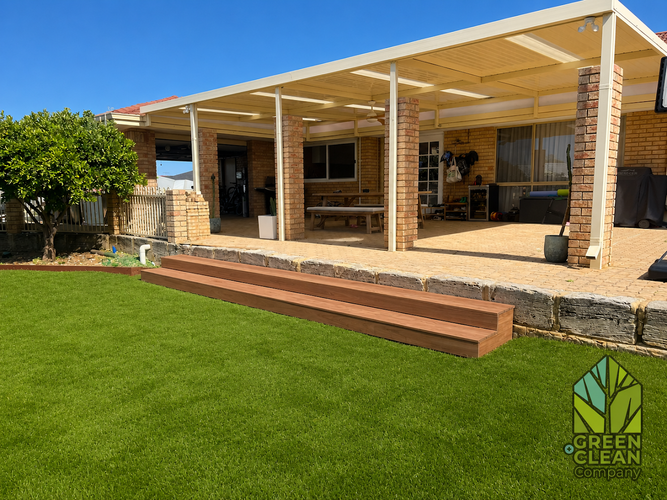 Artificial turf with timber steps and paved patio