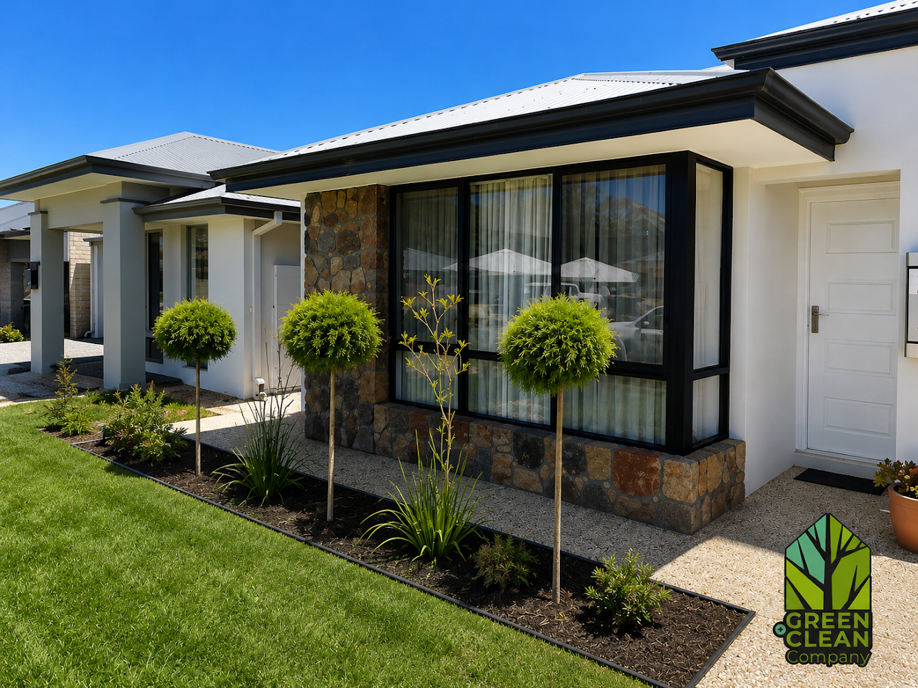 Manicured front lawn with topiary garden beds