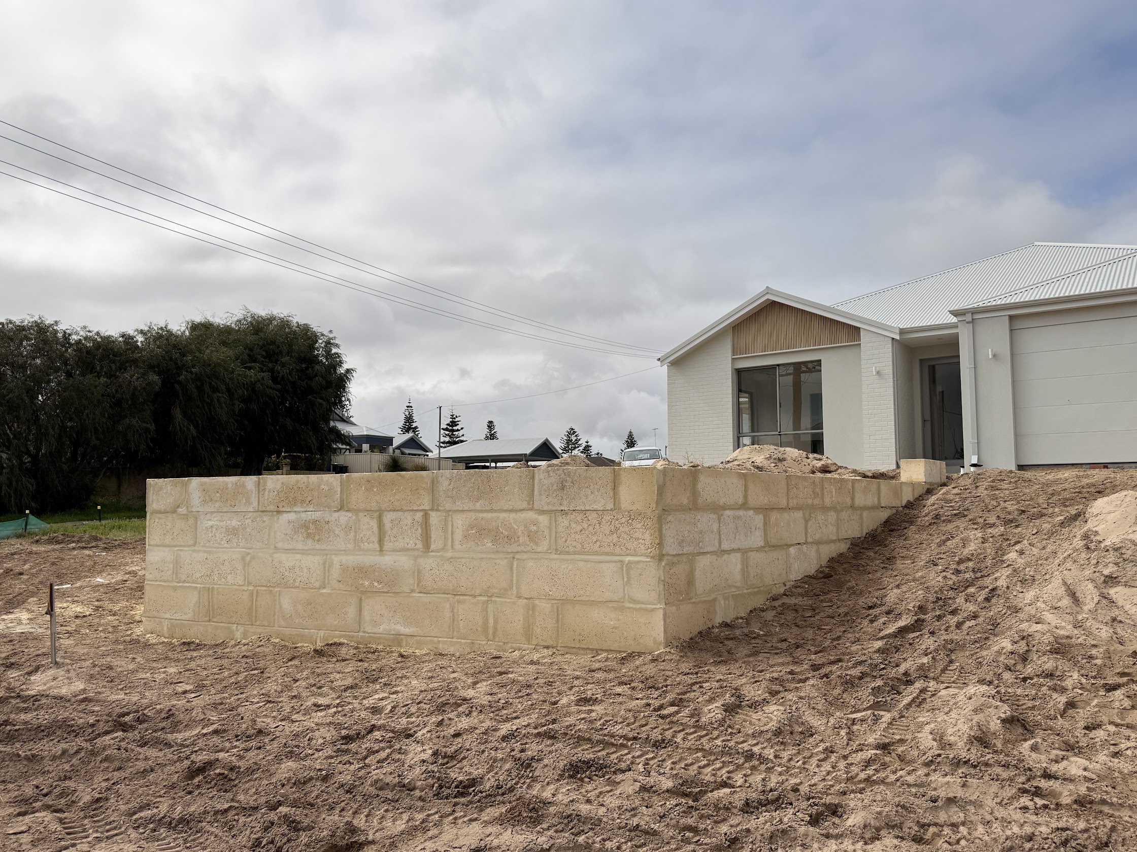 New limestone block retaining wall under construction