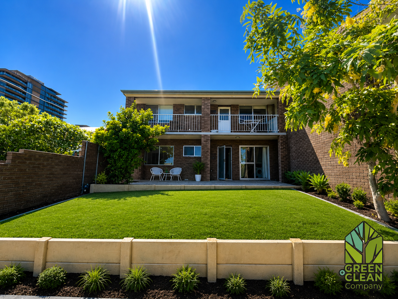 Synthetic turf lawn with sleeper retaining wall and garden bed