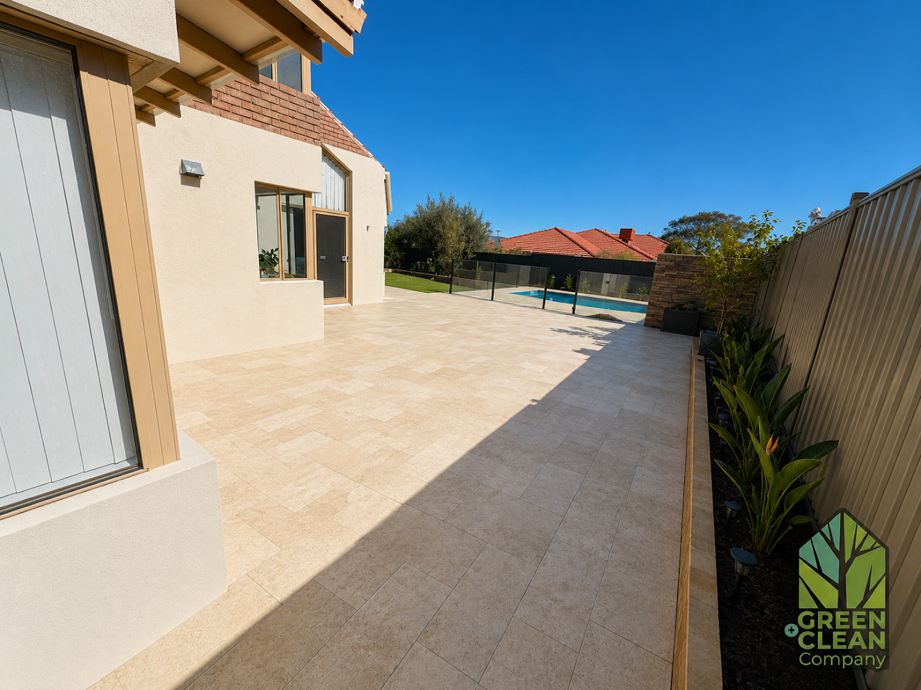 Large paved patio wrapping around the house