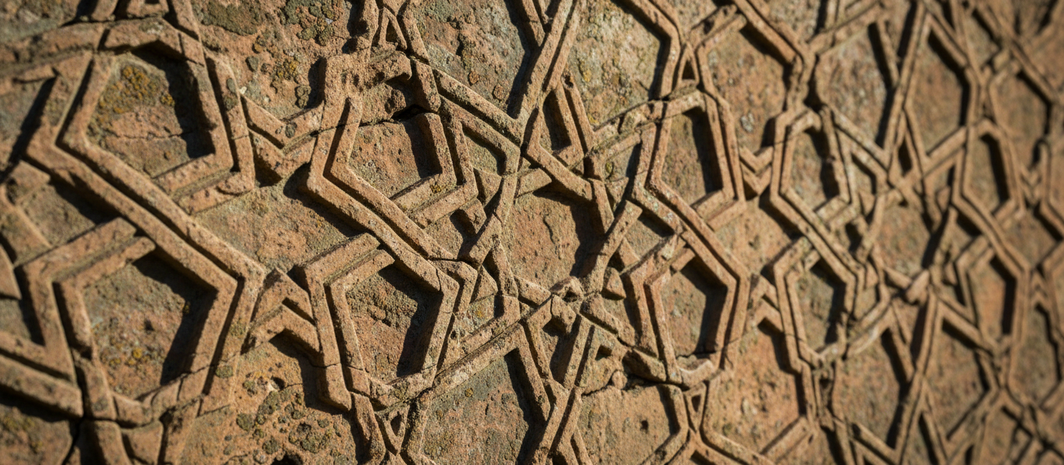 Ancient stone carvings with intricate Islamic geometric patterns