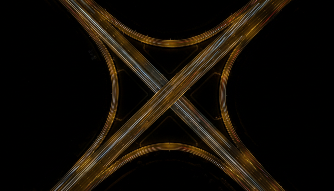Highway interchange at night with light trails