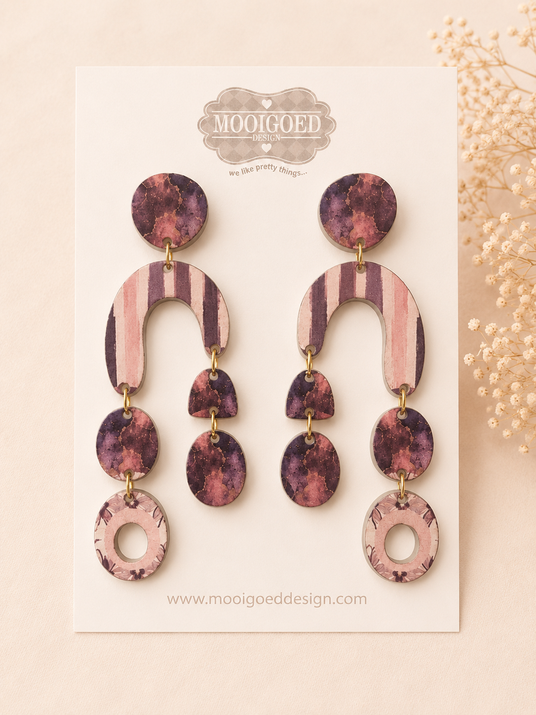 Mooigoed Design statement earrings on a branded display card