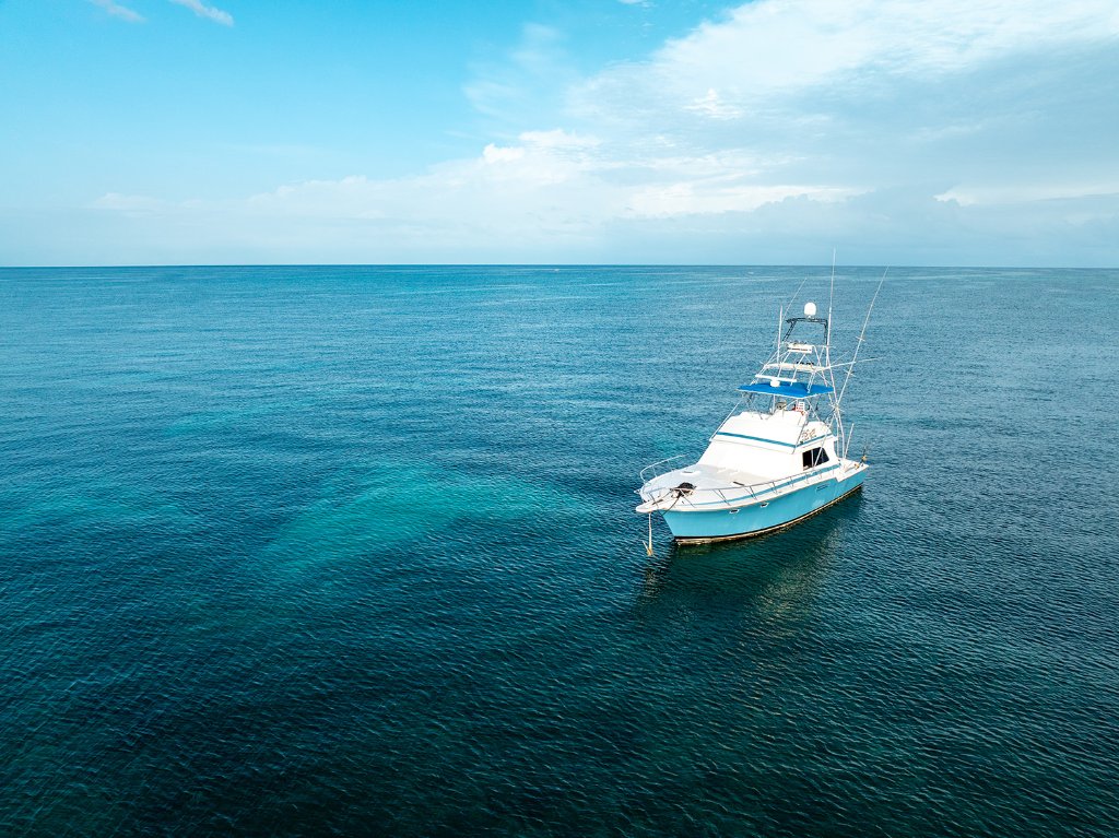 Head First sportfisher cruising over Negril's turquoise waters