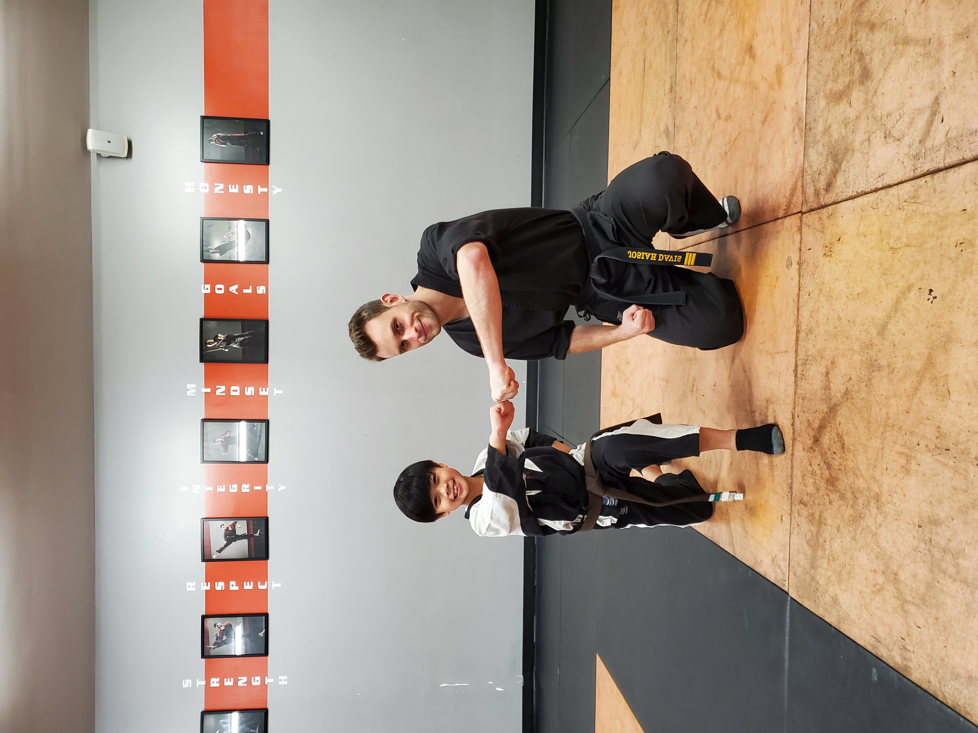 Coach and young student fist bumping in a kids martial arts class in Richmond BC