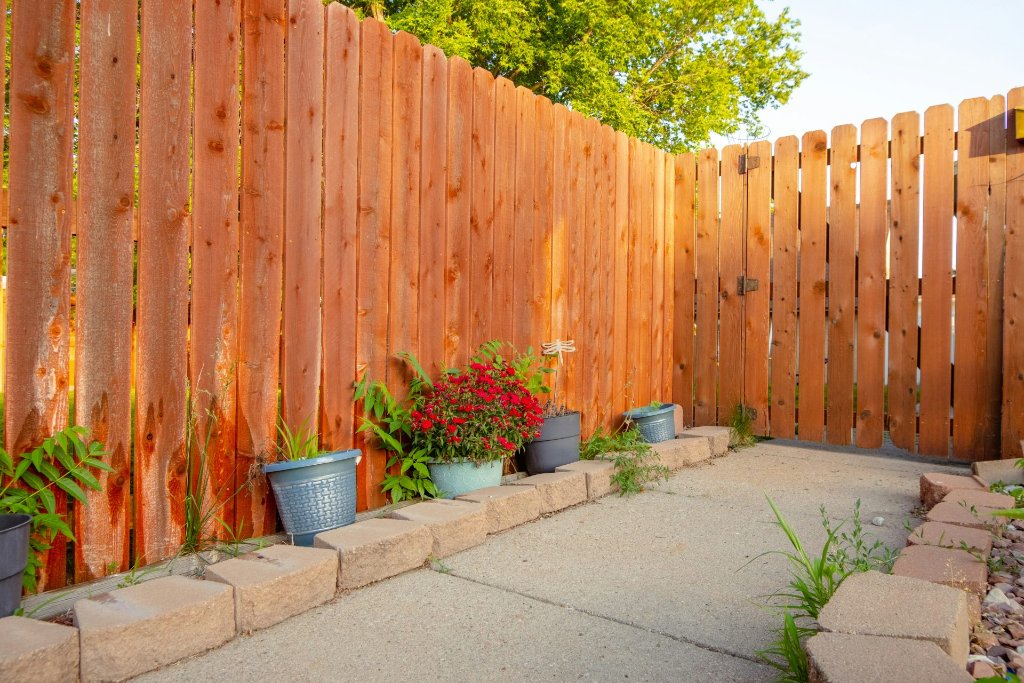 Wood privacy fence backyard with planters