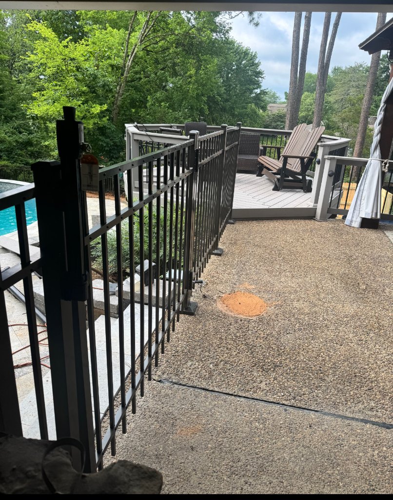 Black aluminum fence around a pool deck on a Tennessee residential property