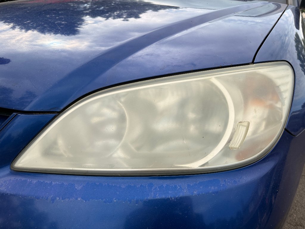 Honda Civic headlight before restoration — foggy, oxidized, yellowed headlight lens in Portland, OR