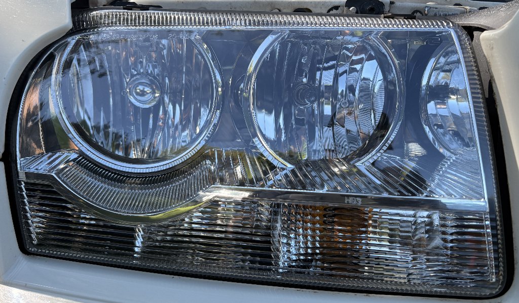 Cadillac headlight after professional restoration — clear, bright headlight lens in Gresham, OR by Bruno's Headlight Restoration