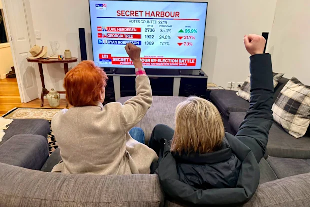 One Nation supporters celebrate as early results show Luke Herdegen leading the Secret Harbour by-election count.
