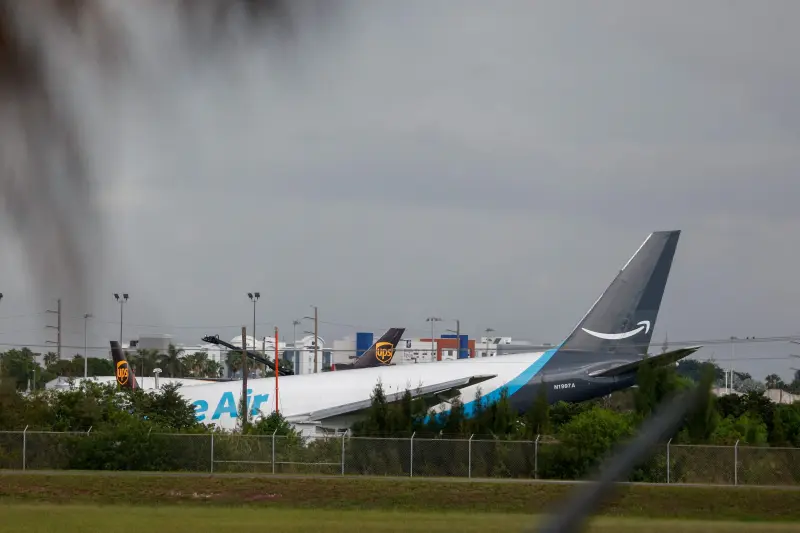 Amazon Prime Air Boeing 767 cargo plane resting near airport perimeter