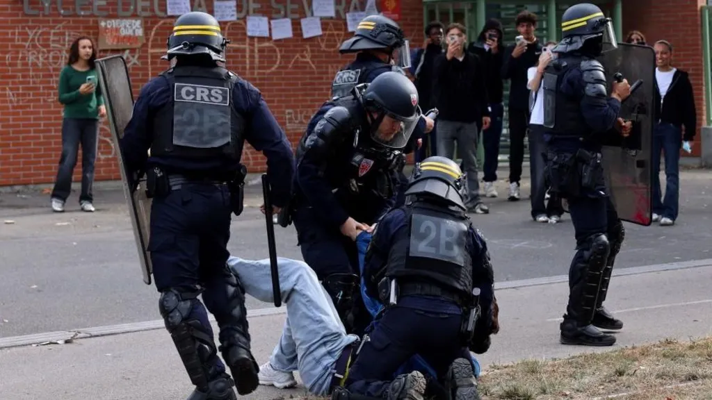 Riot police apprehend a protester