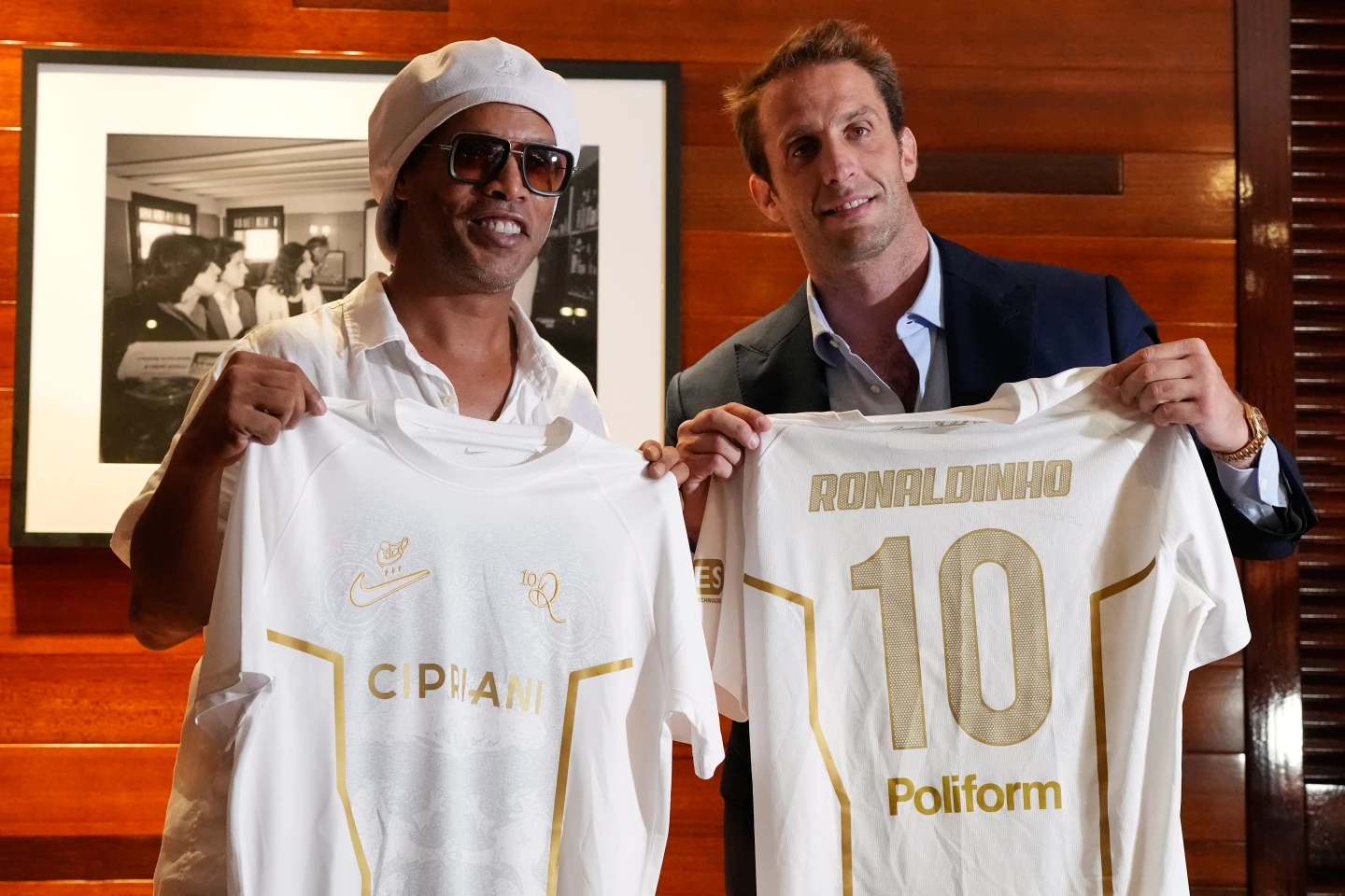 Ronaldinho and Ravenna president Ignazio Cipriani holding branded jerseys