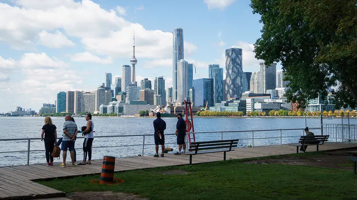 The Toronto waterfront along Lake Ontario, with the CN Tower visible in the skyline.