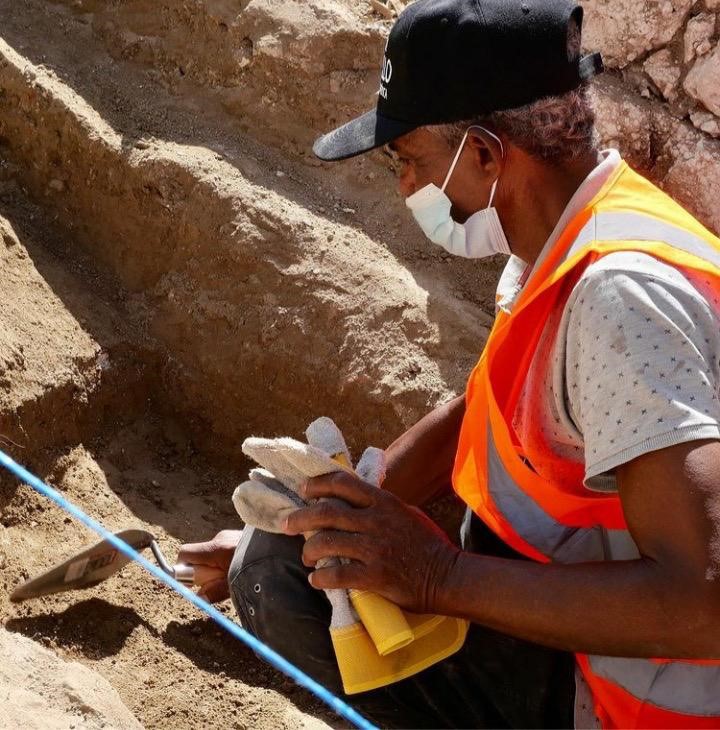 Archaeologist working in a trench at a Dominican Republic excavation site