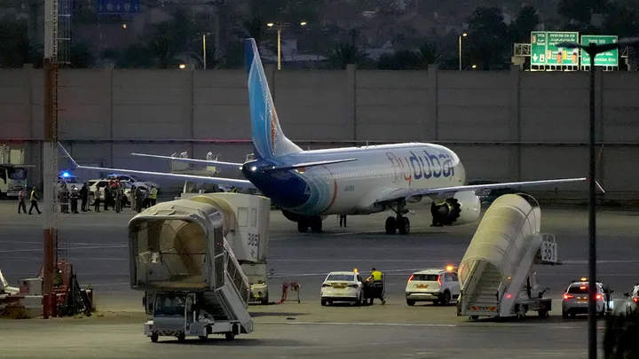 flydubai Boeing 737 parked on the tarmac at night