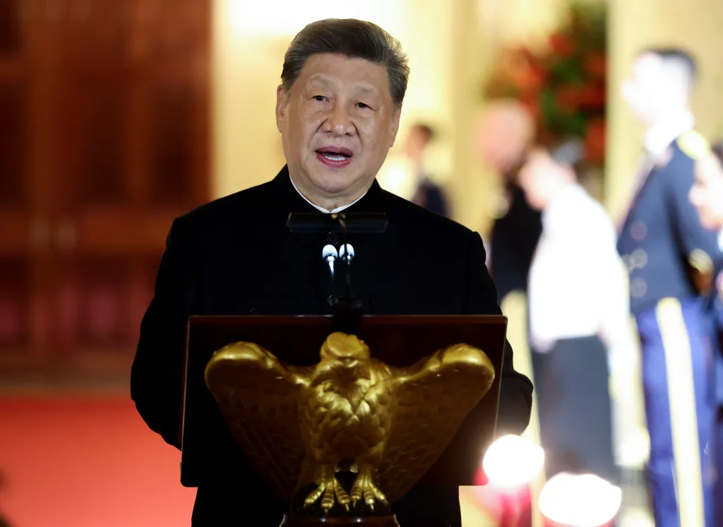 Xi Jinping speaks at a podium with a golden eagle lectern