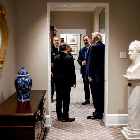 West Wing hallway with staffers conversing