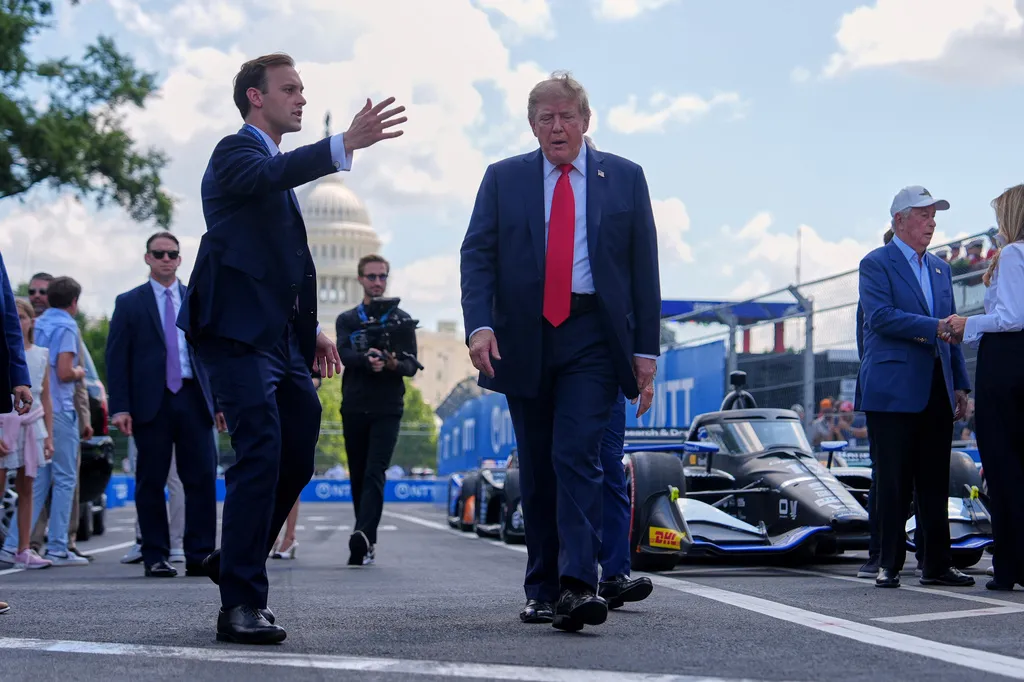 President Donald Trump walks the Freedom 250 track with the U.S. Capitol in the background