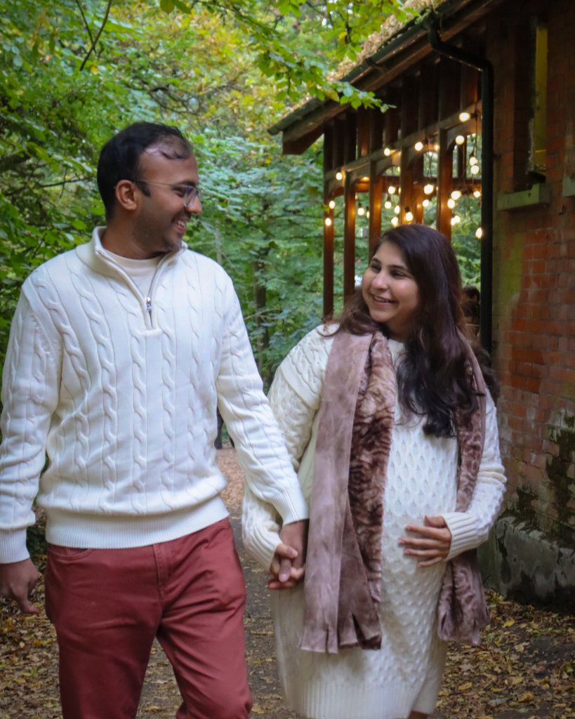 Couple walking by historic building maternity