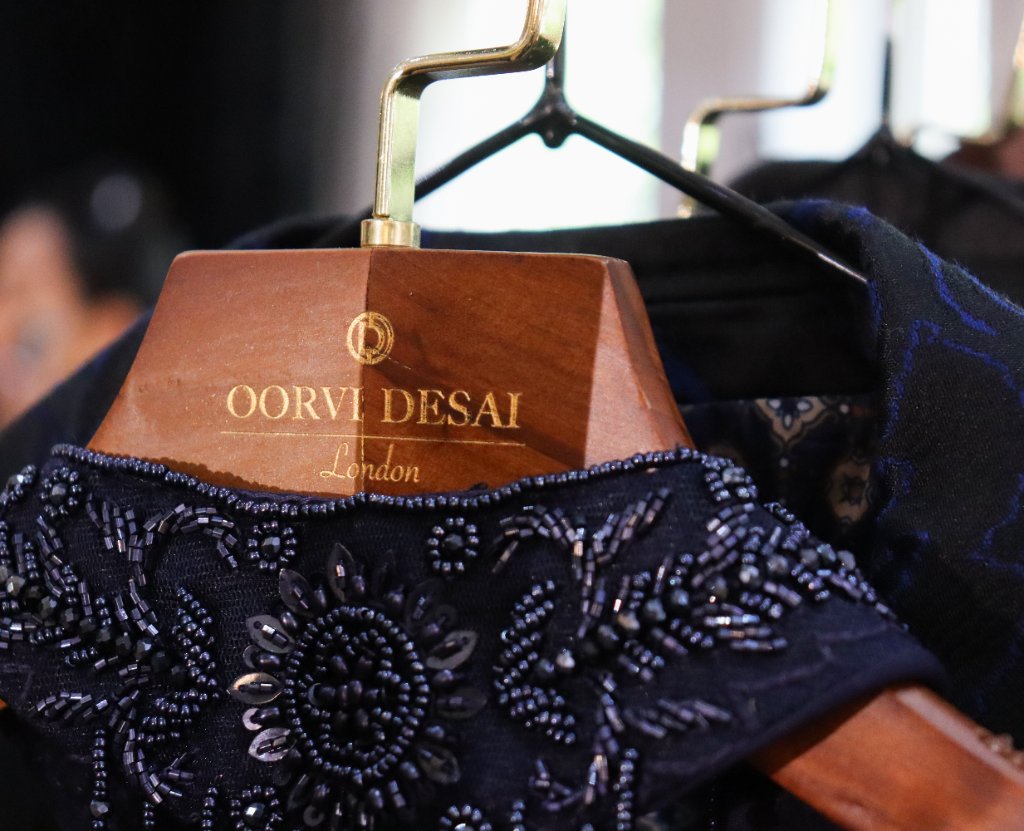 Oorvi Desai London branded clothing on wooden hanger