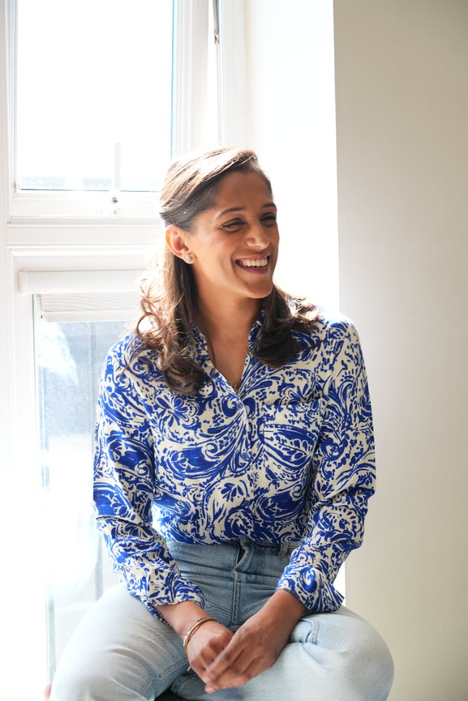 Portrait in blue patterned shirt by window