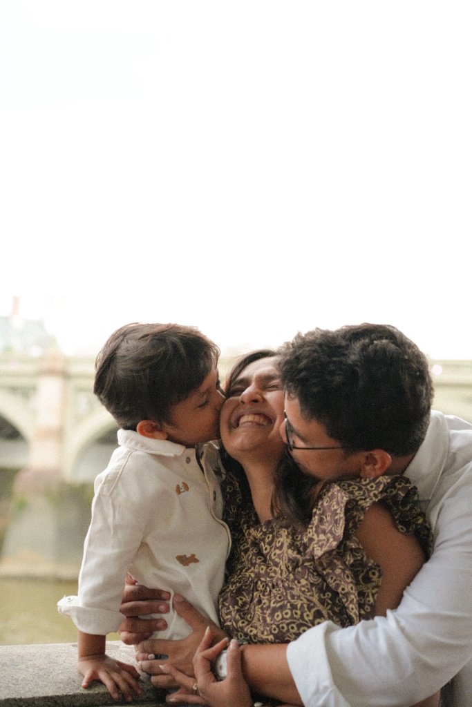 Family sharing kisses together by the river