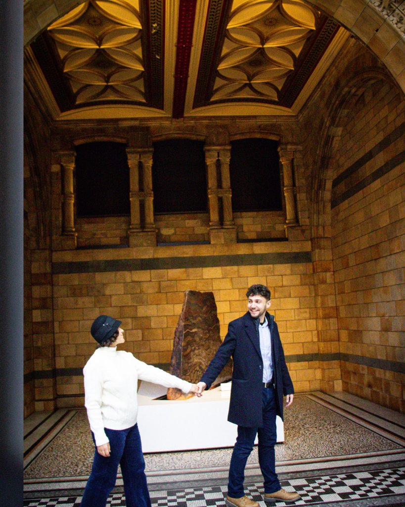 Couple holding hands in museum hall