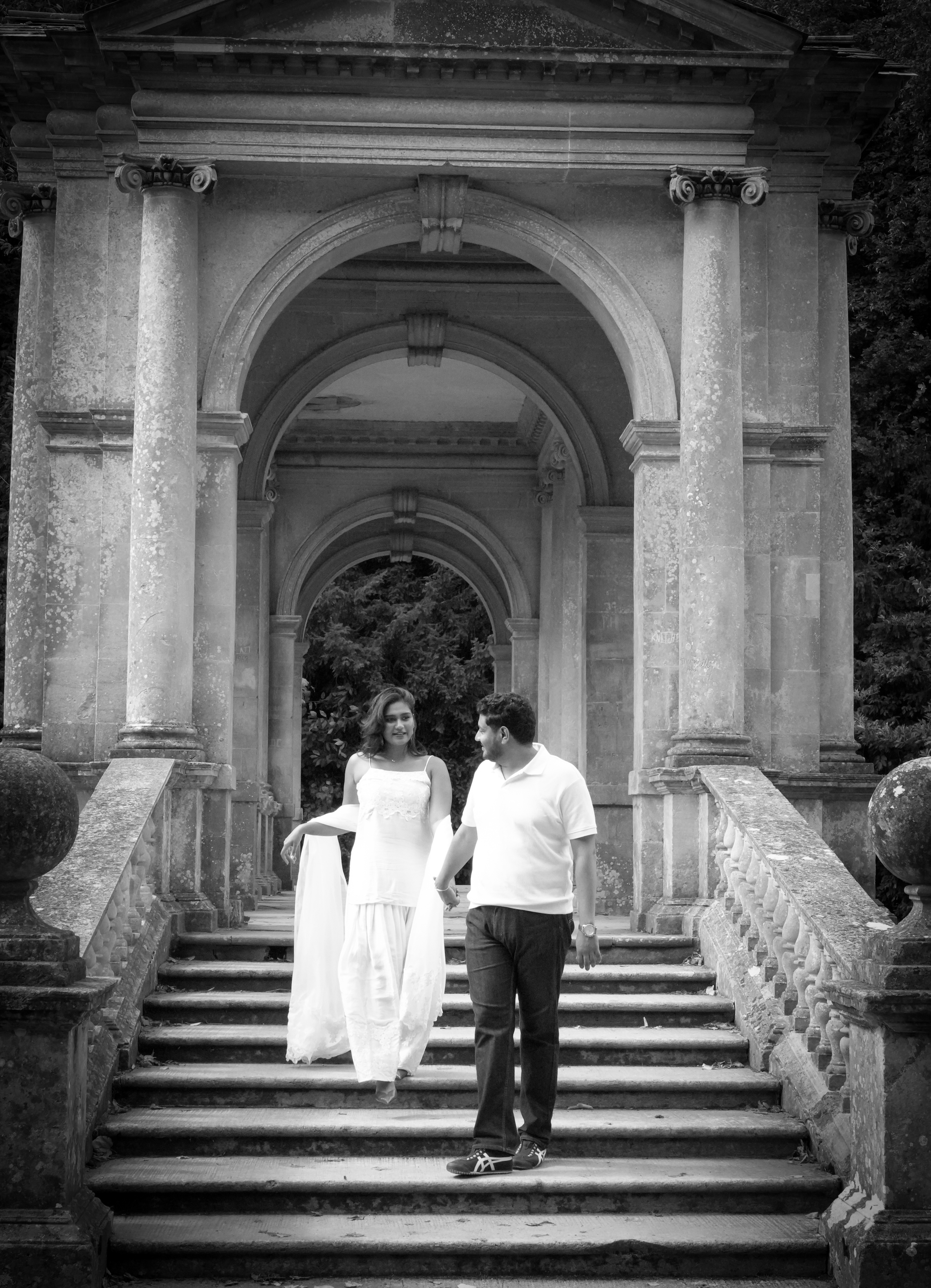 Black and white couple walking down stone staircase