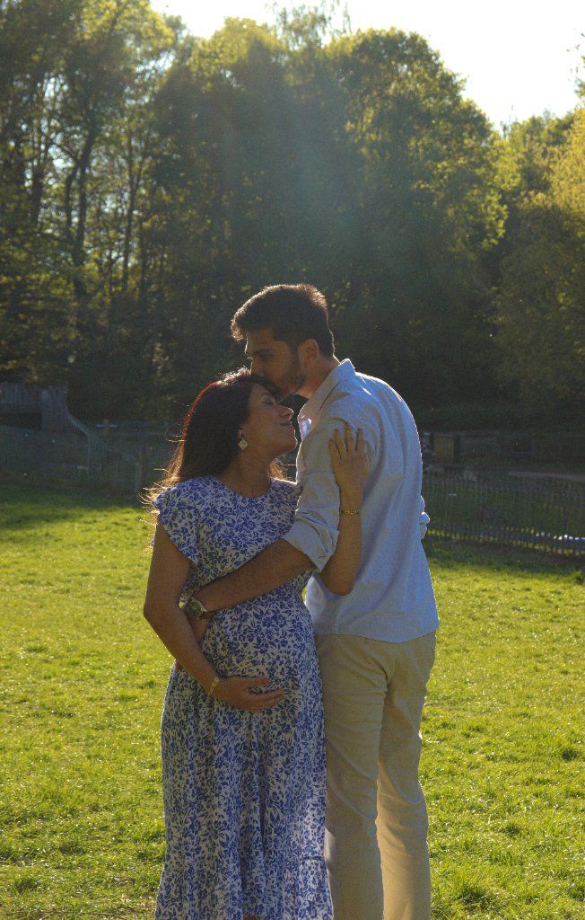 Couple moment in golden light maternity