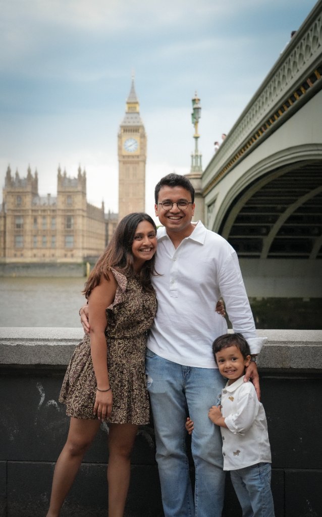 Family of three in front of Big Ben and Westminster Bridge