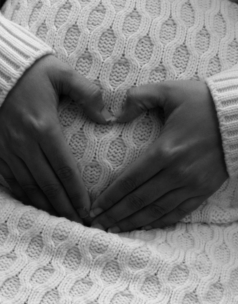 Hands making heart shape maternity detail