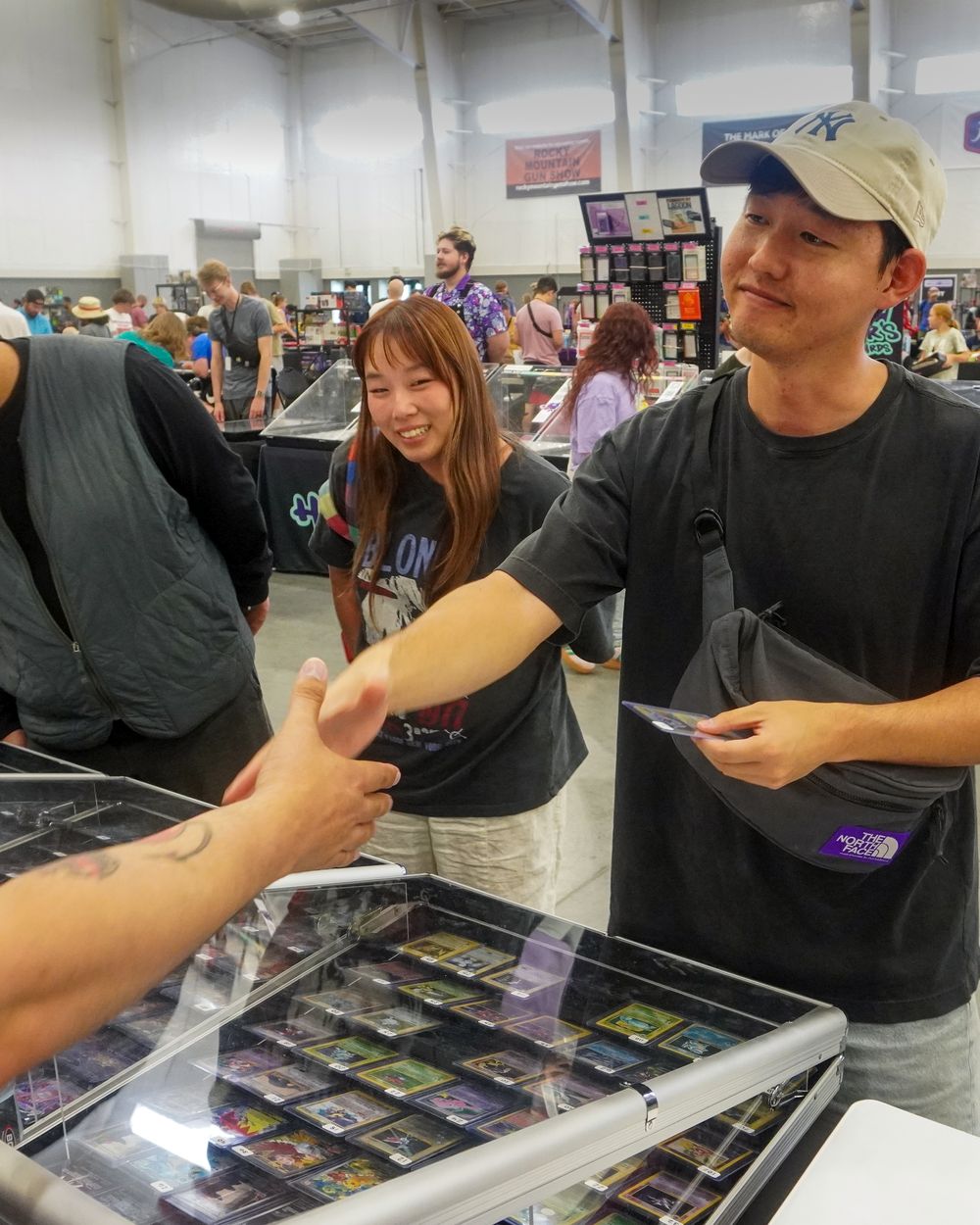 A CardFellas trade wrapping up with a handshake over the display case