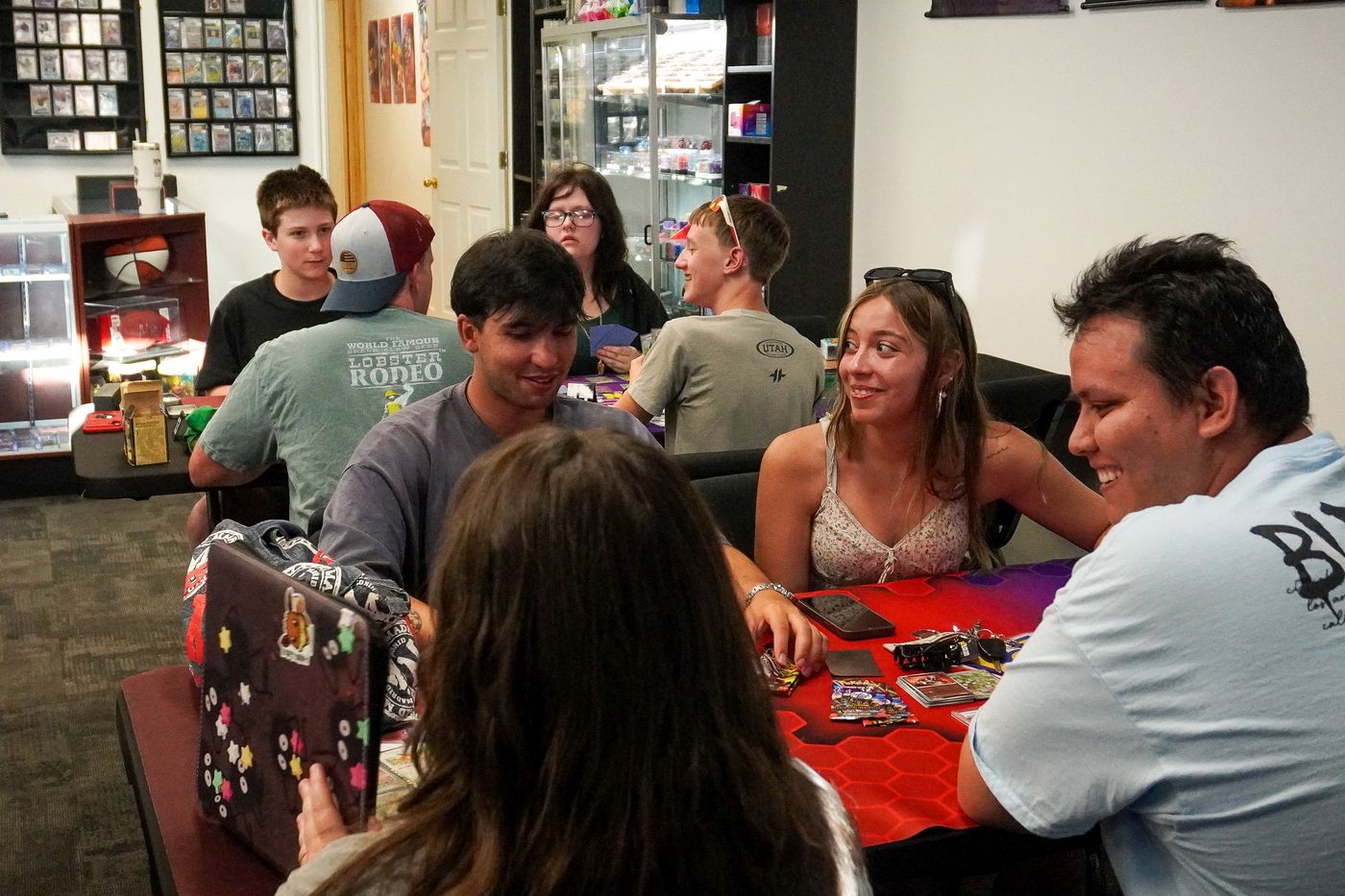 Players laughing around a table in the CardFellas play room
