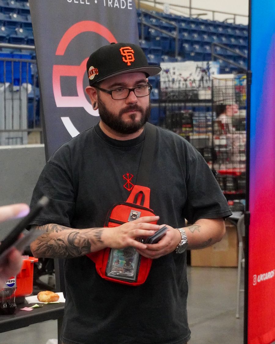 CardFellas team member at the booth in front of the brand banner