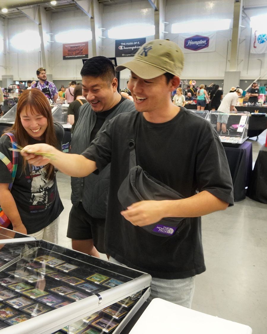 A collector handing over a card at the CardFellas case